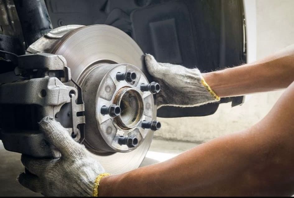 Mechanic replacing car brake pads at Handy Speedy Mechanical Workshop in Kingston upon Hull